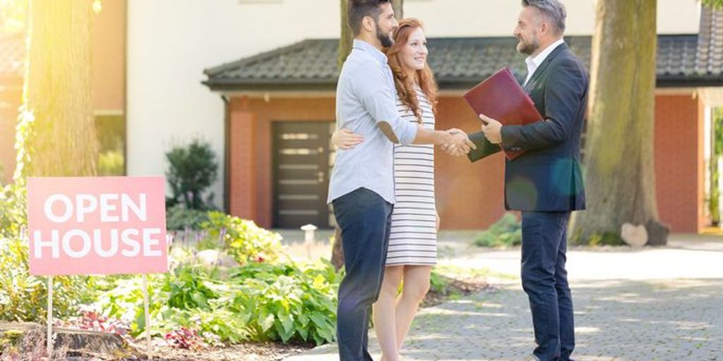 real estate agent showing house to couple in Imperial Beach