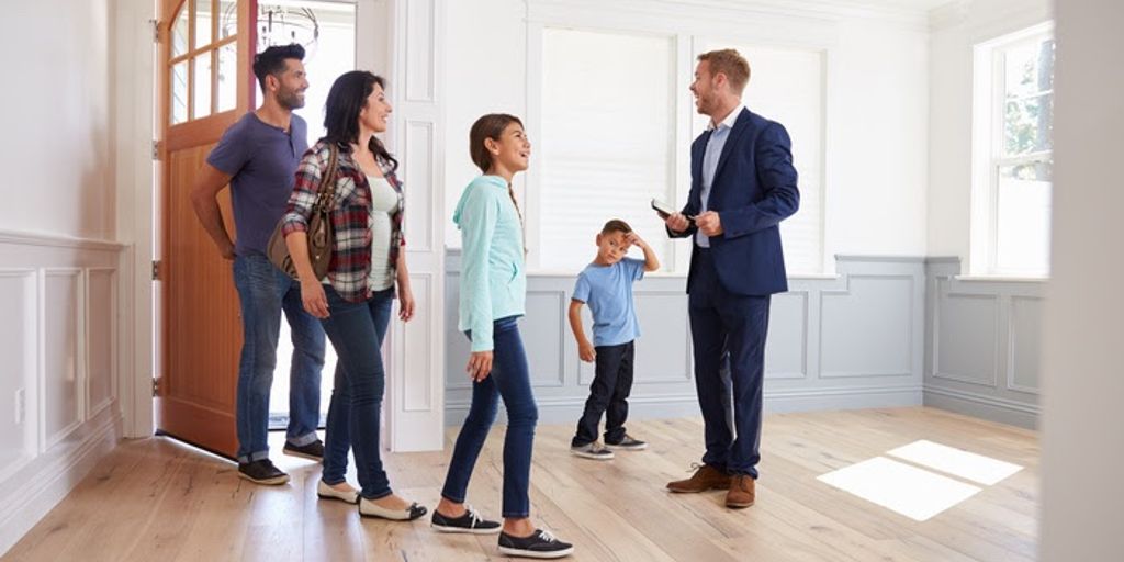 happy family selling house to real estate agent in Barstow