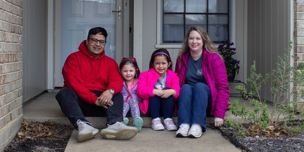happy family in front of sold house in Placentia