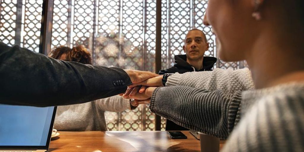 people shaking hands in front of a house in Santa Monica