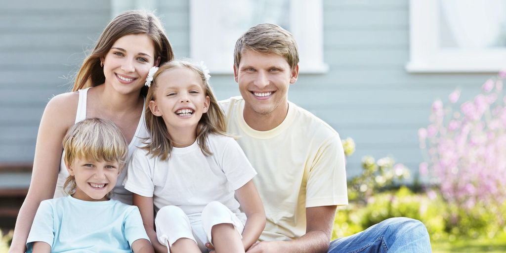 happy family in front of a sold house in Stanton