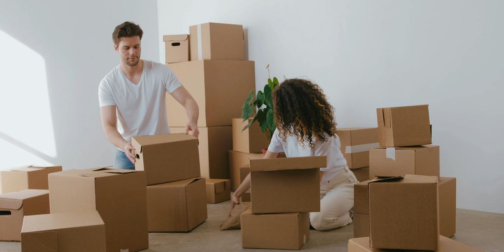 family packing moving boxes in Holtville home