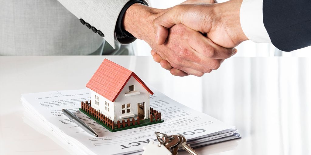 real estate agent shaking hands with client in front of house in Poway