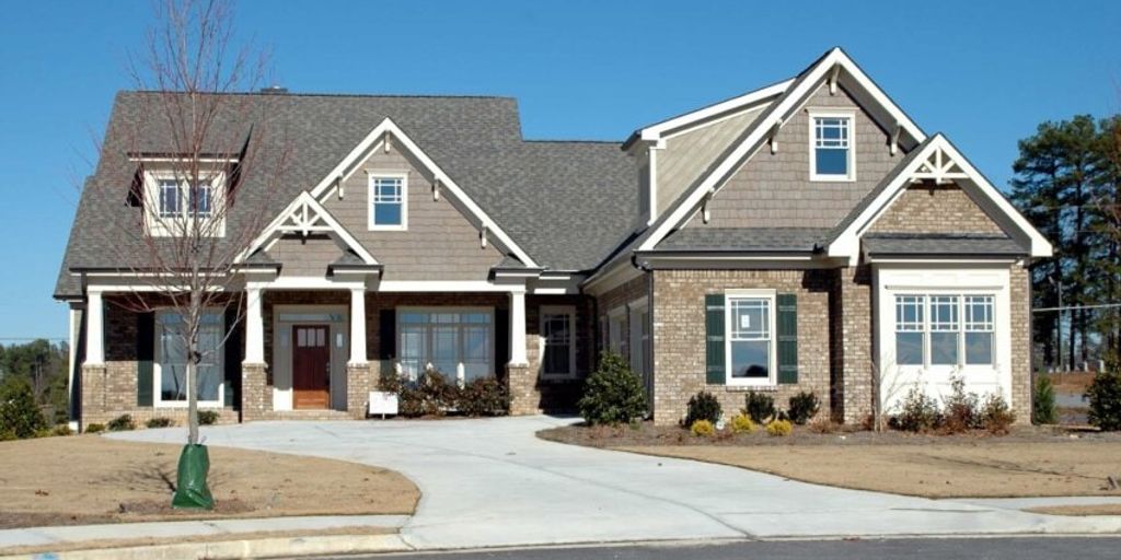 house for sale sign in suburban neighborhood